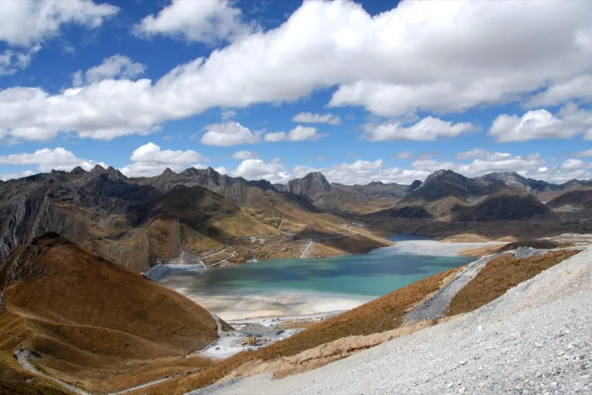 Aerial photograph of the Antamina mine tailings pond in the Peruvian Andes, turquoise water framed by high-altitude mountain terrain